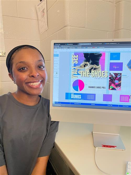 Saginaw High School yearbook student posing with yearbook cover